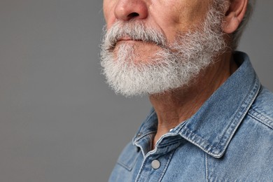 Photo of Man with mustache on grey background, closeup. Space for text