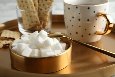 Photo of Refined sugar cubes in bowl on table, closeup