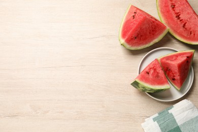 Photo of Slices of tasty ripe watermelon on light wooden table, flat lay. Space for text