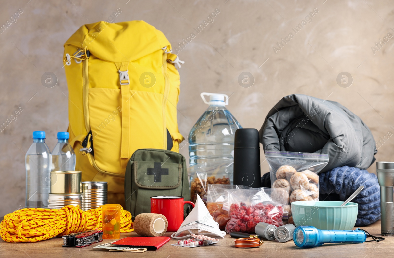 Photo of Disaster supply kit for earthquake on wooden table