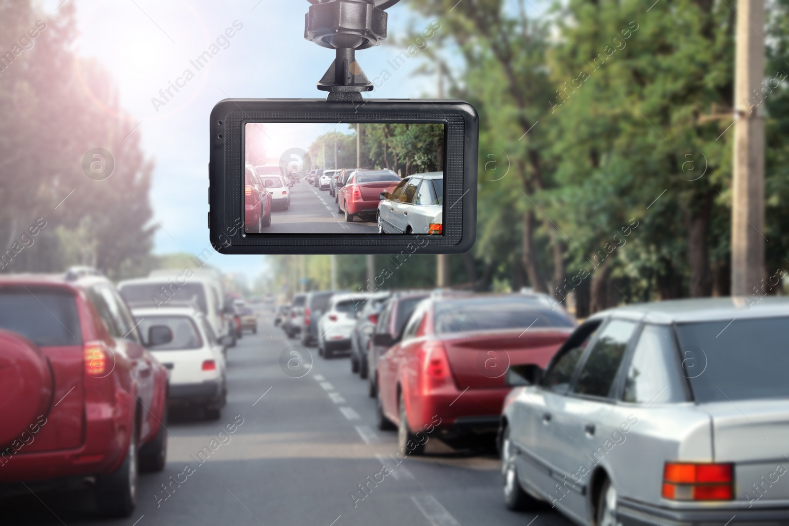 Image of Modern dashboard camera mounted in car, view of road during driving