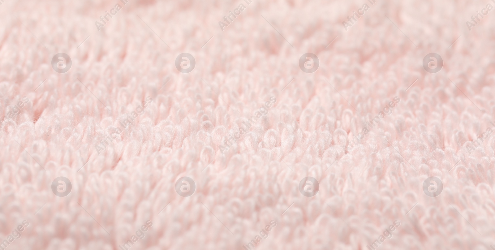 Photo of Texture of soft light pink fabric as background, closeup