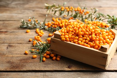 Ripe sea buckthorn berries on wooden table