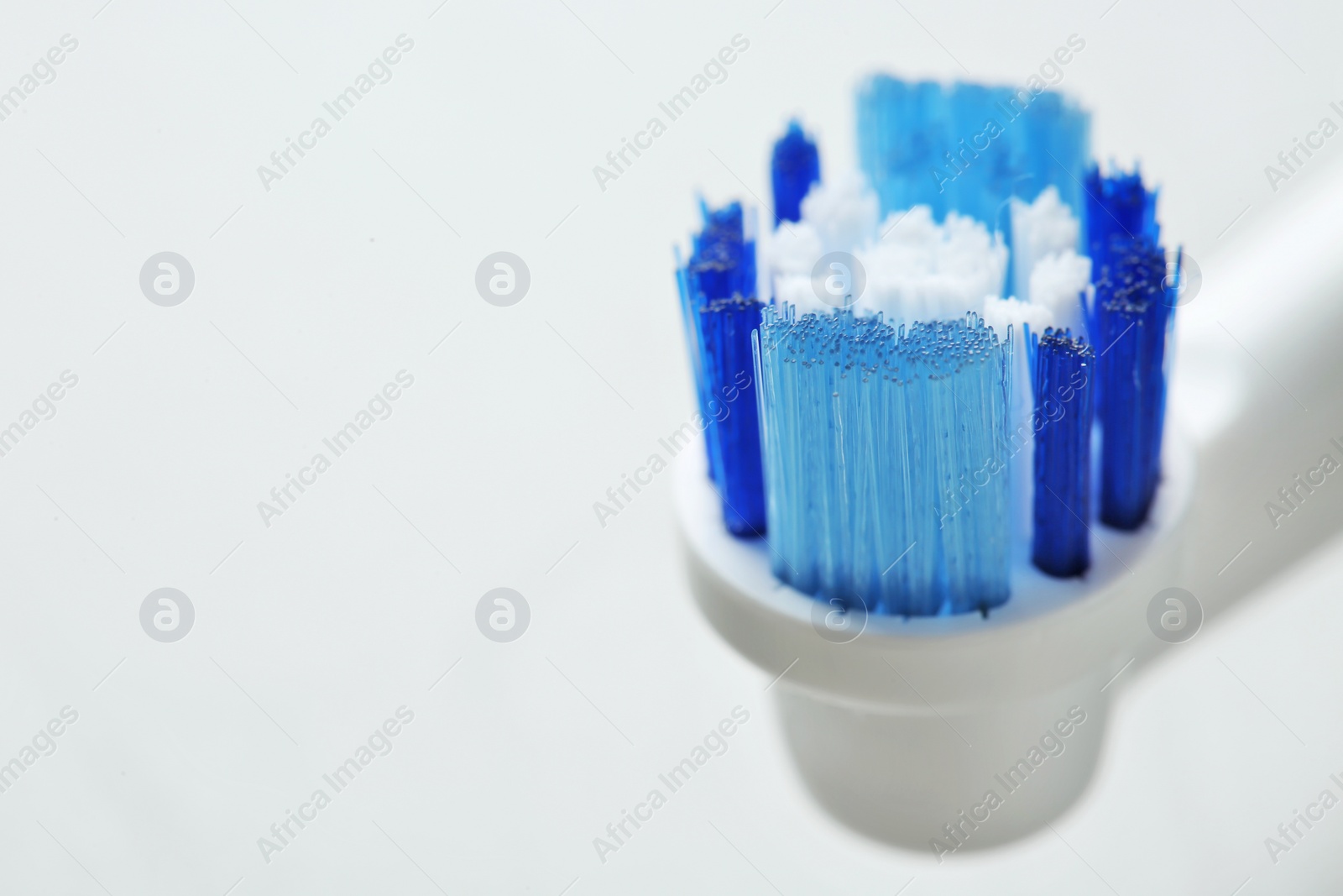 Photo of Electric toothbrush on gray background, close up