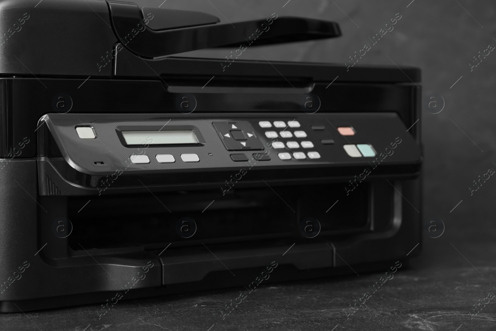 Photo of Closeup view of new modern printer with control panel on black background