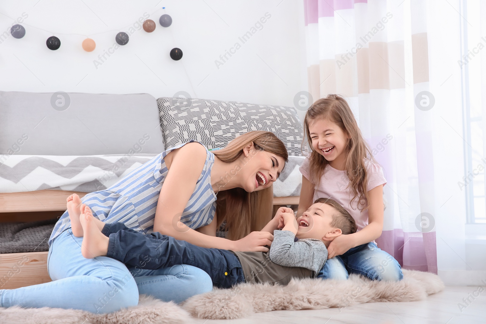 Photo of Nanny and little children playing at home