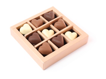 Photo of Delicious heart shaped chocolate candies in box isolated on white