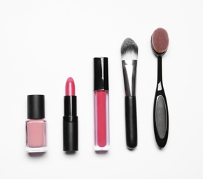 Set of makeup products on white background, top view