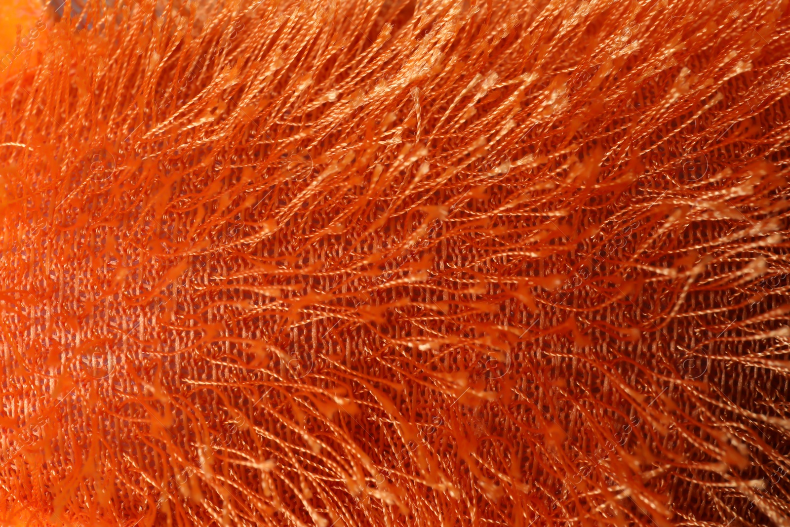 Photo of Texture of orange knitted fuzzy fabric as background, closeup