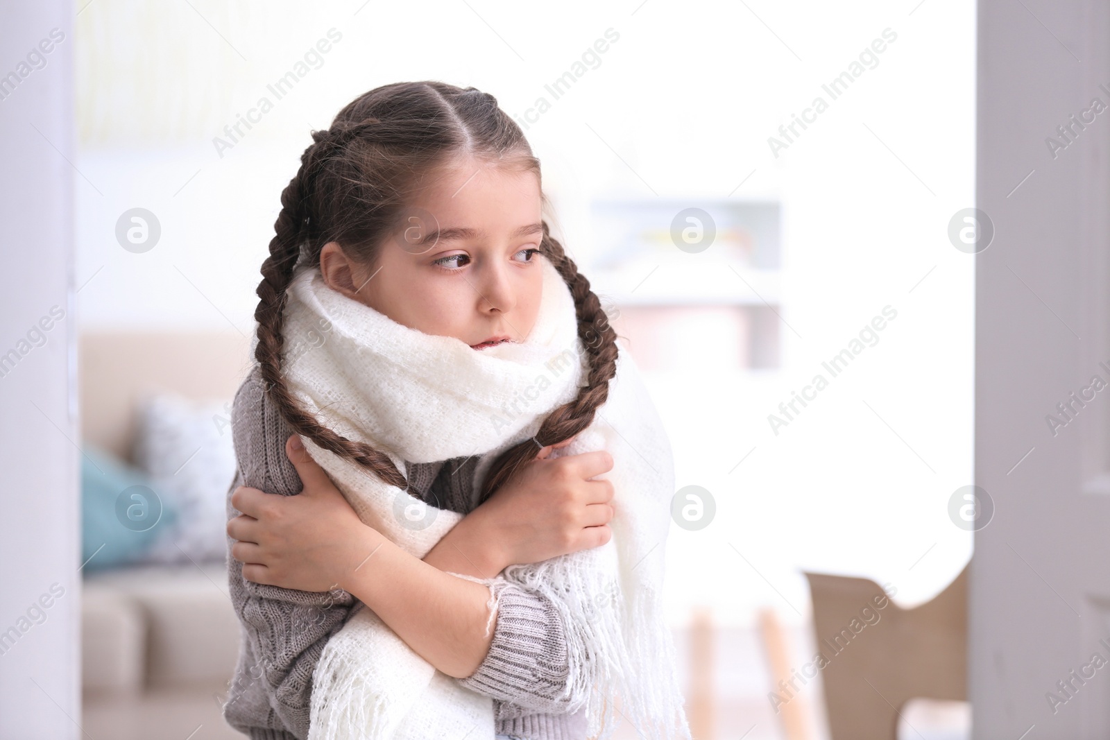 Photo of Sad little girl suffering from cold on blurred background