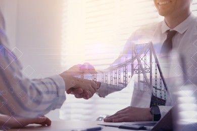 Double exposure of bridge and business partners shaking hands in office, closeup