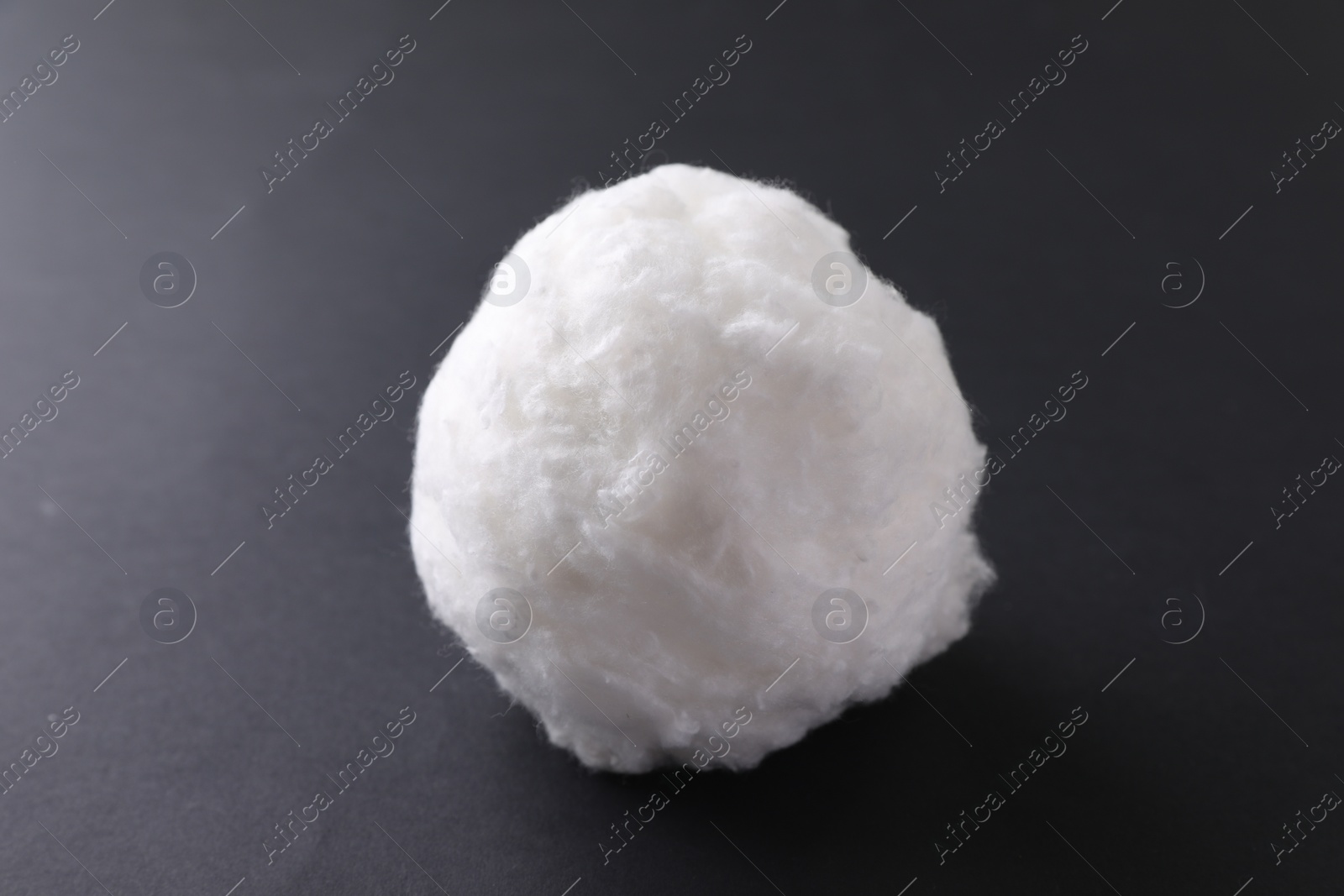 Photo of Ball of clean cotton wool on grey background, closeup