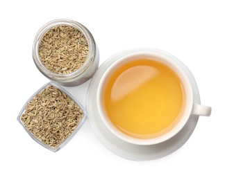 Aromatic fennel tea in cup and seeds isolated on white, top view