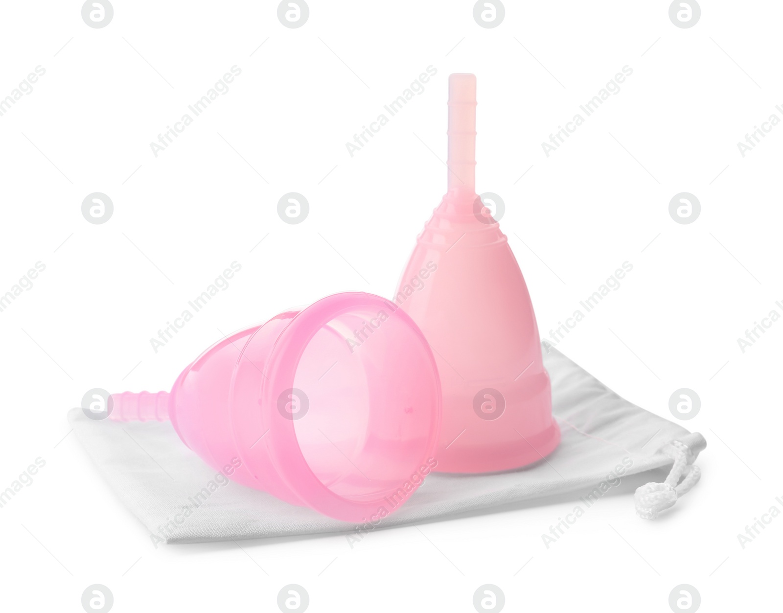 Photo of Pink menstrual cups with cotton bag on white background