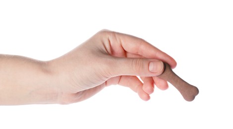 Woman holding bone shaped dog cookie on white background, closeup