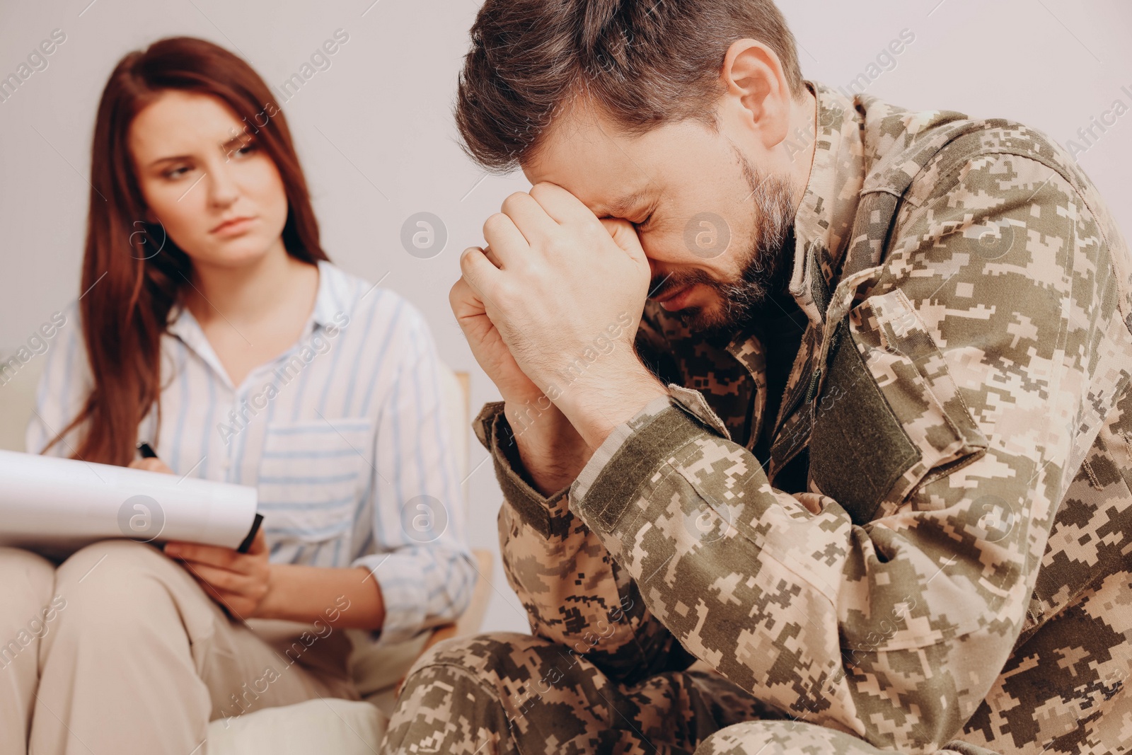 Photo of Psychologist working with military officer in office