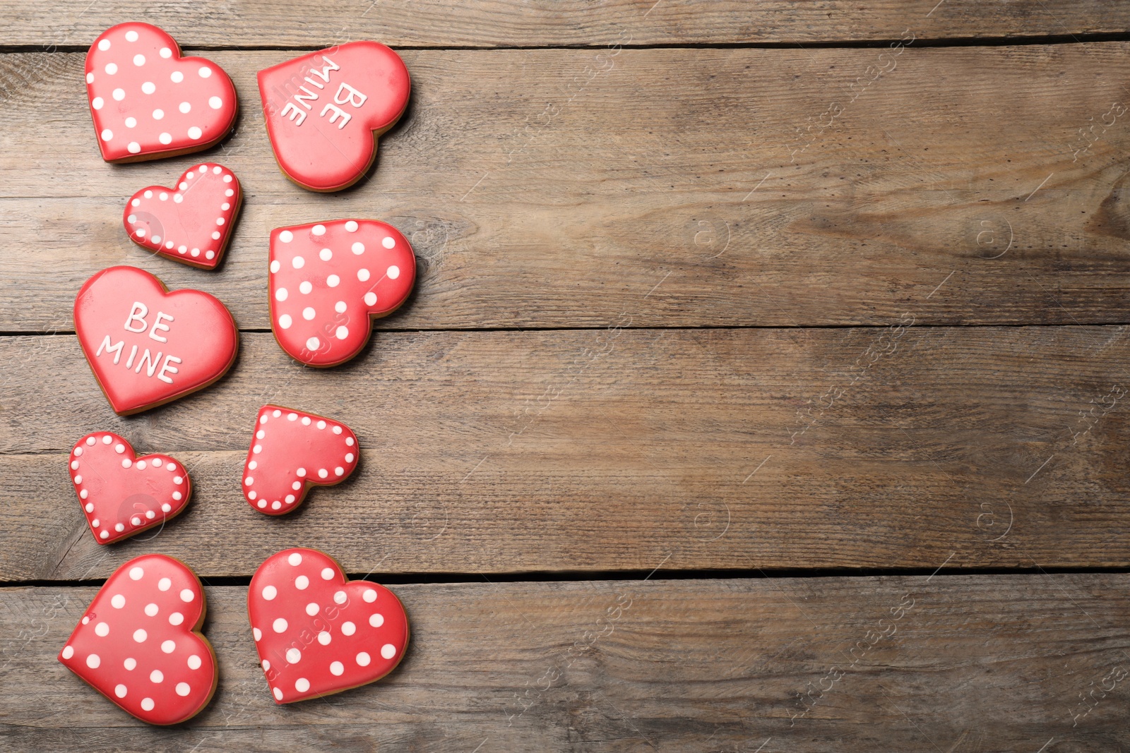 Photo of Heart shaped cookies on wooden table, flat lay with space for text. Valentine's day treat