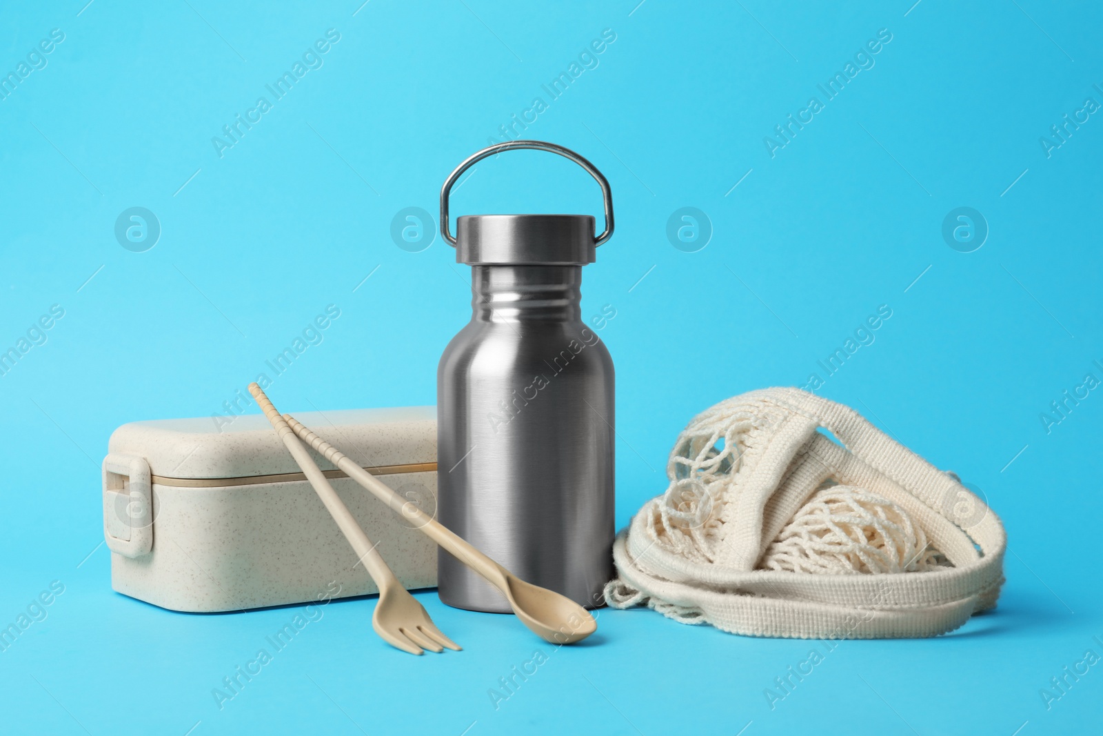 Photo of Composition with eco friendly products on light blue background. Conscious consumption