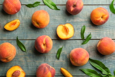 Fresh sweet peaches on wooden table, flat lay