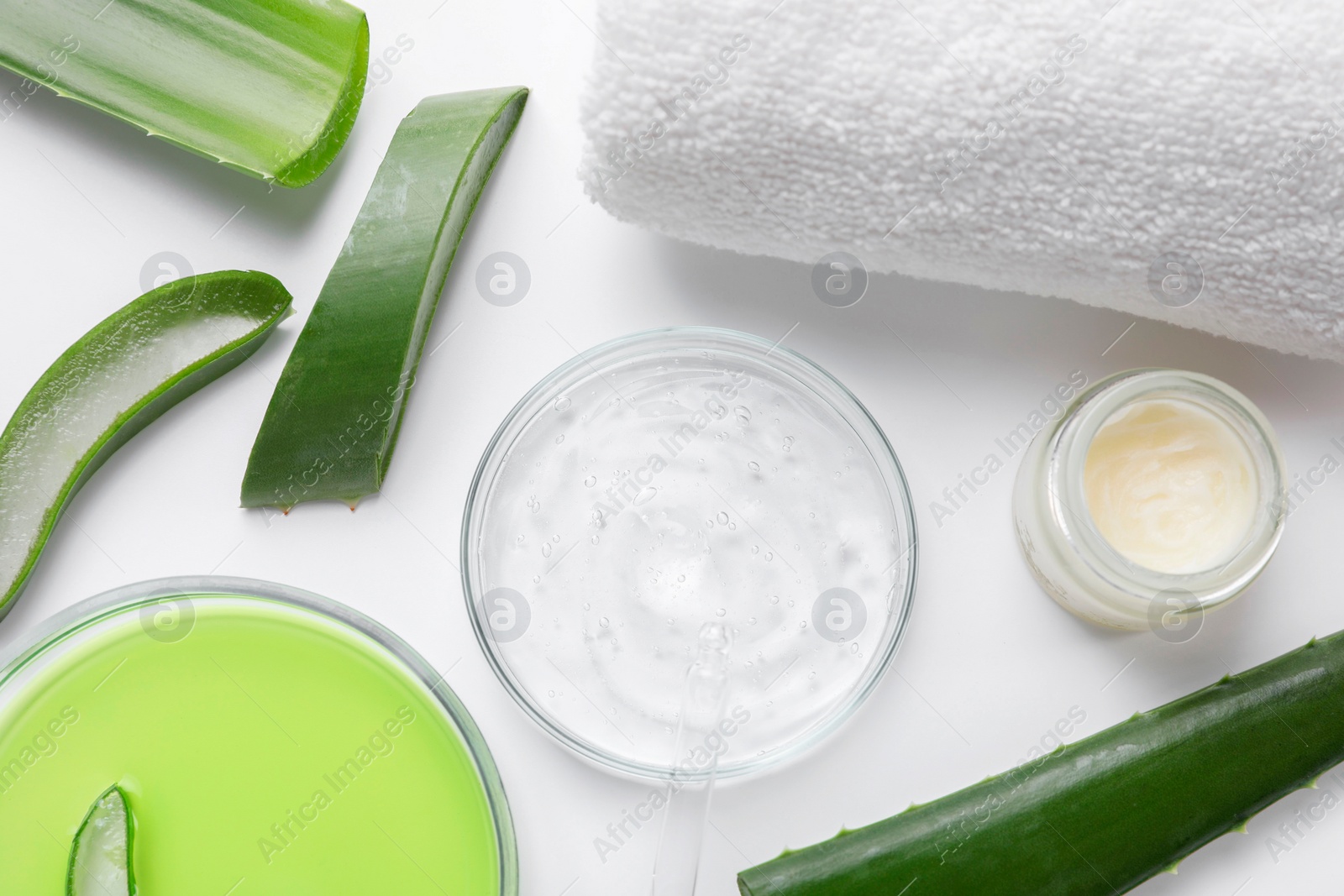 Photo of Flat lay composition with cosmetic products and cut aloe leaves on white background