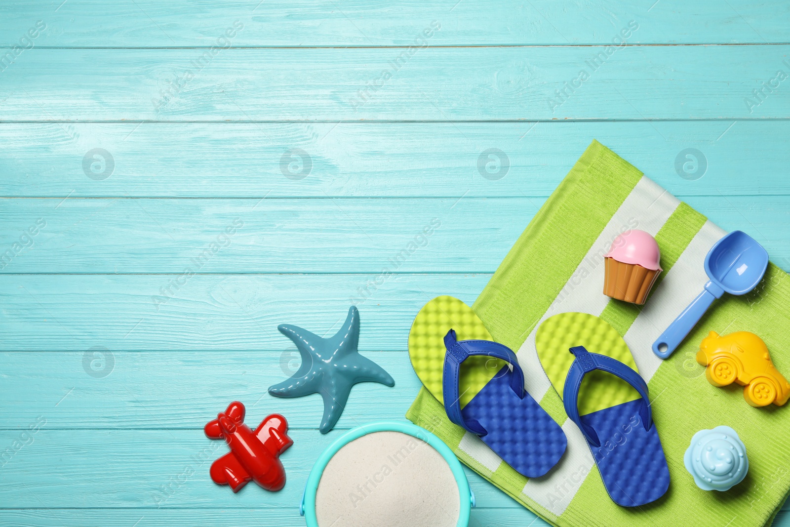 Photo of Flat lay composition with beach toys on color wooden background. Space for text