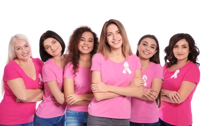 Group of women with silk ribbons on white background. Breast cancer awareness concept