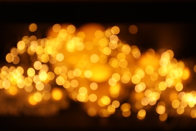 Photo of Gold glitter with bokeh effect on dark background