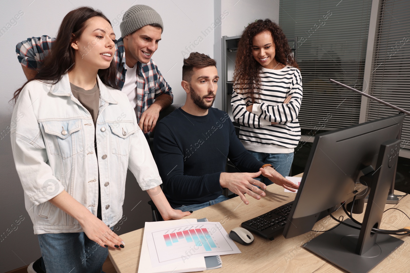 Photo of Team of employees working together in office. Startup project