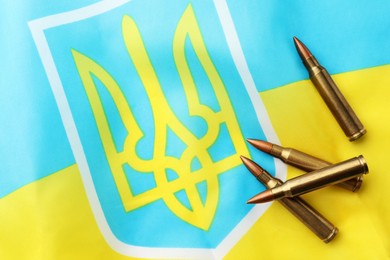 Photo of Bullets on national flag of Ukraine, top view