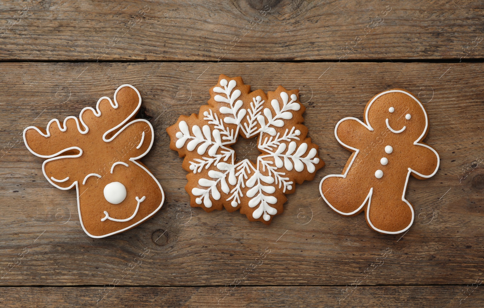 Photo of Different delicious Christmas cookies on wooden table, flat lay