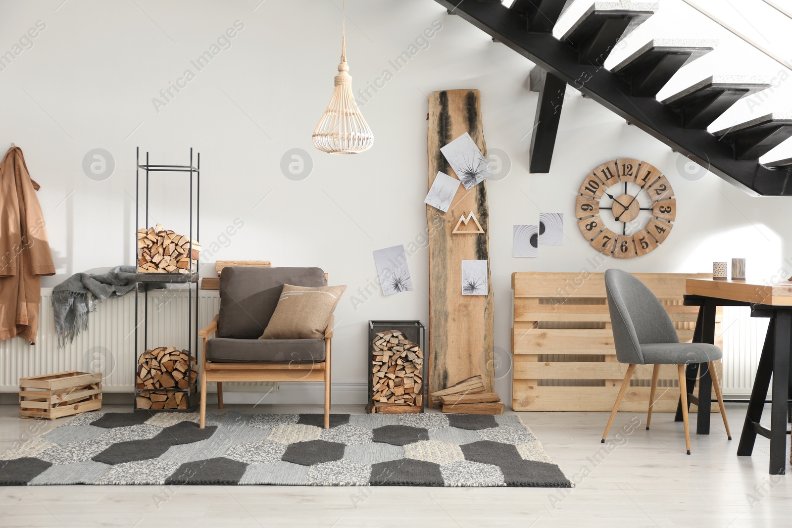 Photo of Stylish room interior with firewood as decorative element