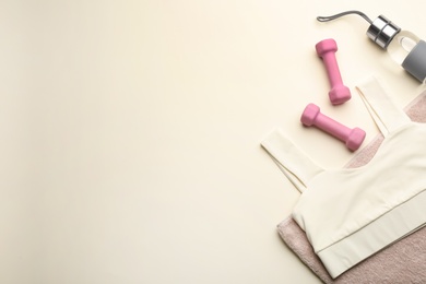 Photo of Flat lay composition with sportswear and equipment on beige background, space for text. Gym workout