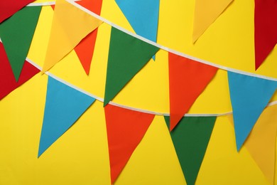 Photo of Buntings with colorful triangular flags on yellow background