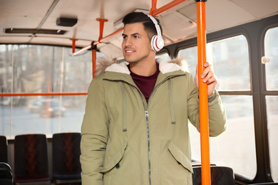 Man listening to audiobook in trolley bus