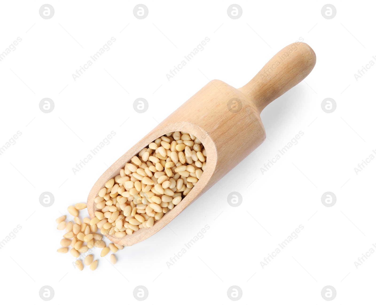 Photo of Scoop with pine nuts on white background, top view