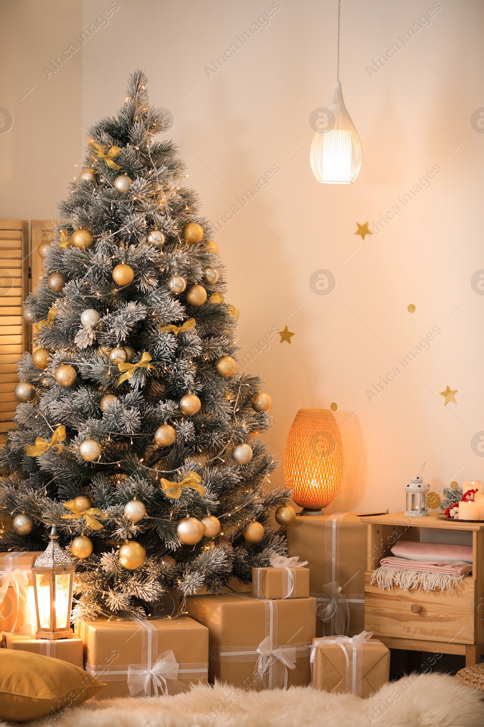 Photo of Beautiful decorated Christmas tree and gift boxes in festive room interior