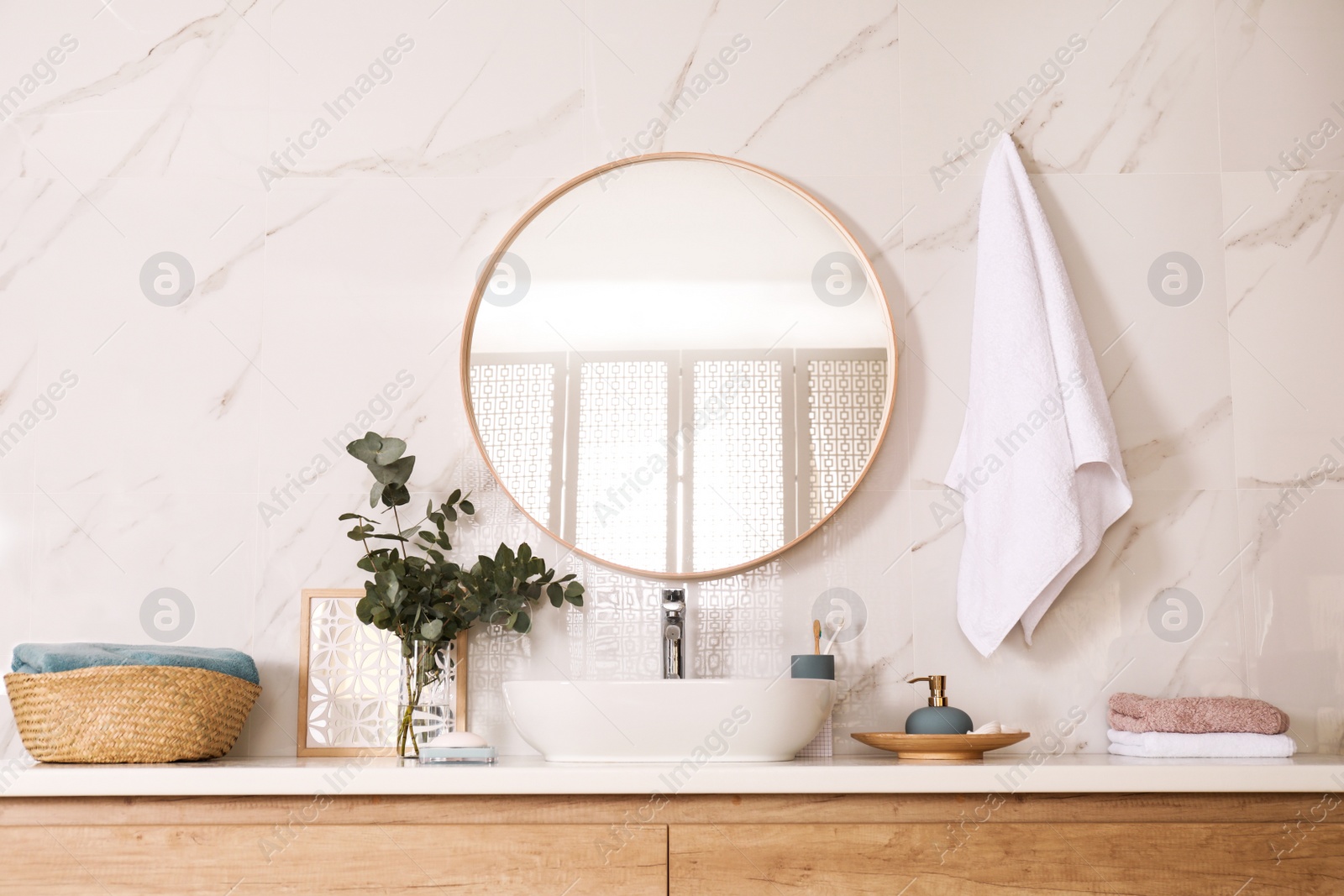 Photo of Stylish bathroom interior with vessel sink and round mirror