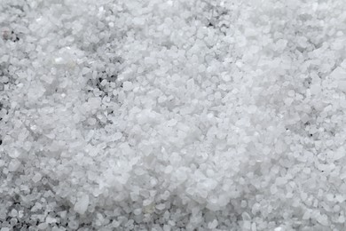 Photo of White natural salt as background, closeup view