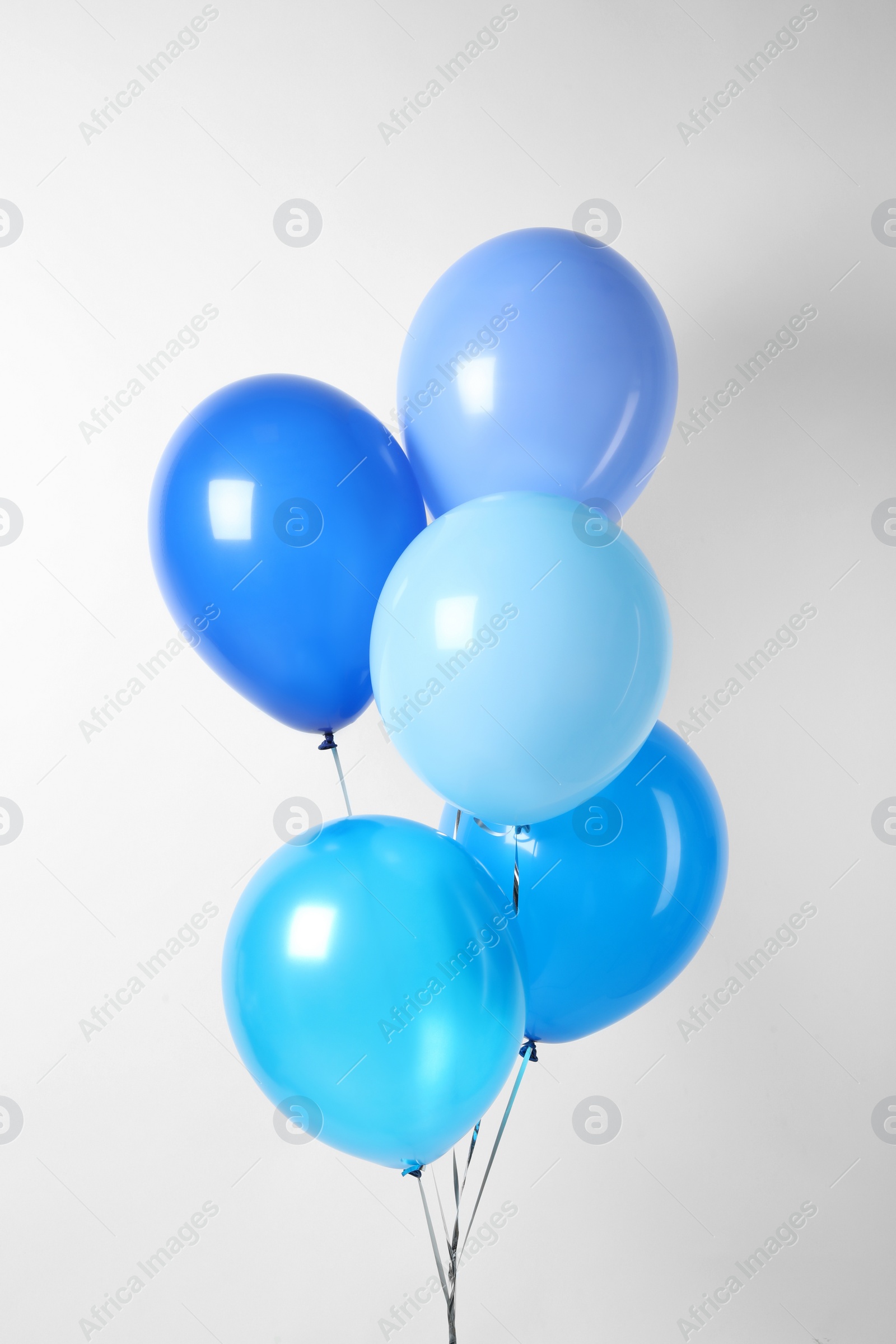 Photo of Bunch of blue balloons on white background. Greeting card