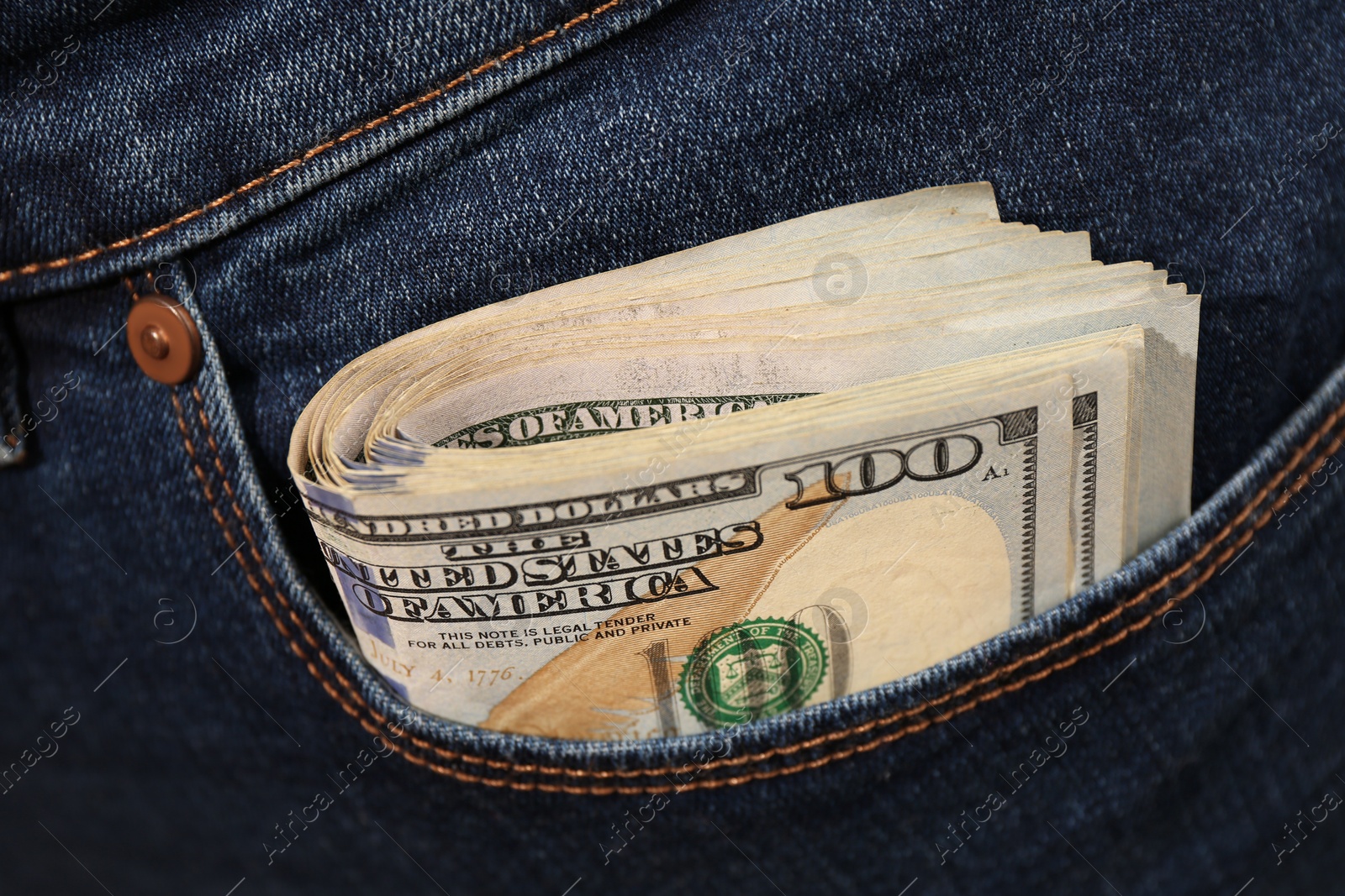 Photo of Dollar banknotes in pocket of jeans, closeup. Spending money