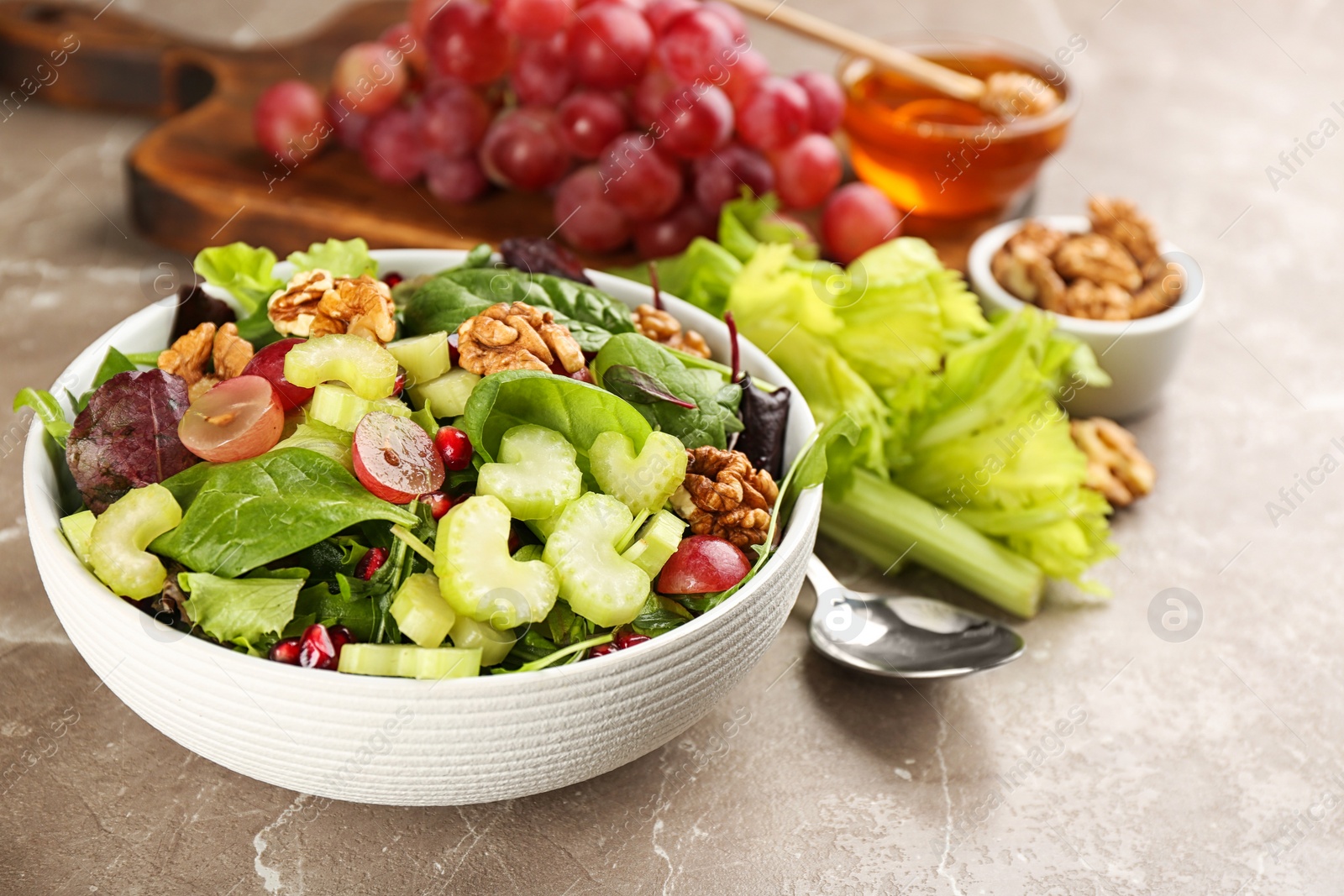 Photo of Delicious fresh celery salad on grey table, closeup