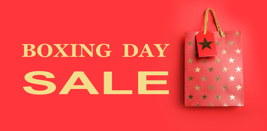 Image of Boxing day sale. Shopping bag on red background, banner design