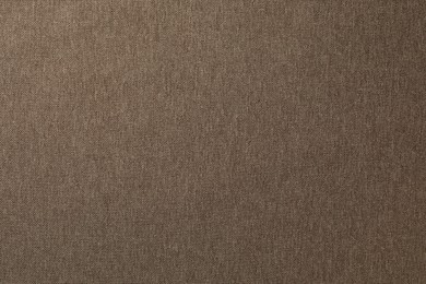 Photo of Texture of brown fabric as background, top view