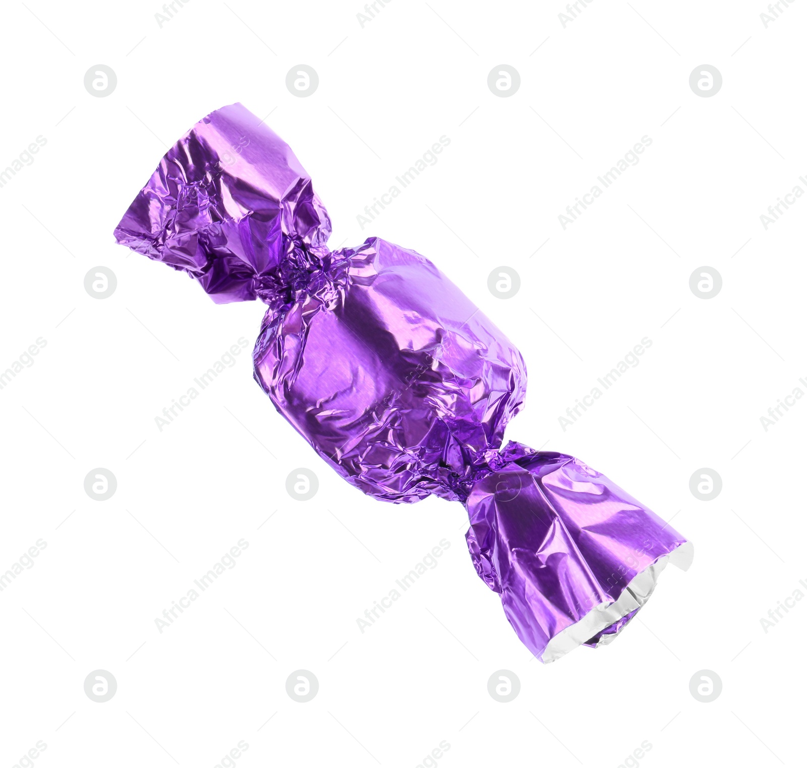Photo of Tasty candy in purple wrapper isolated on white