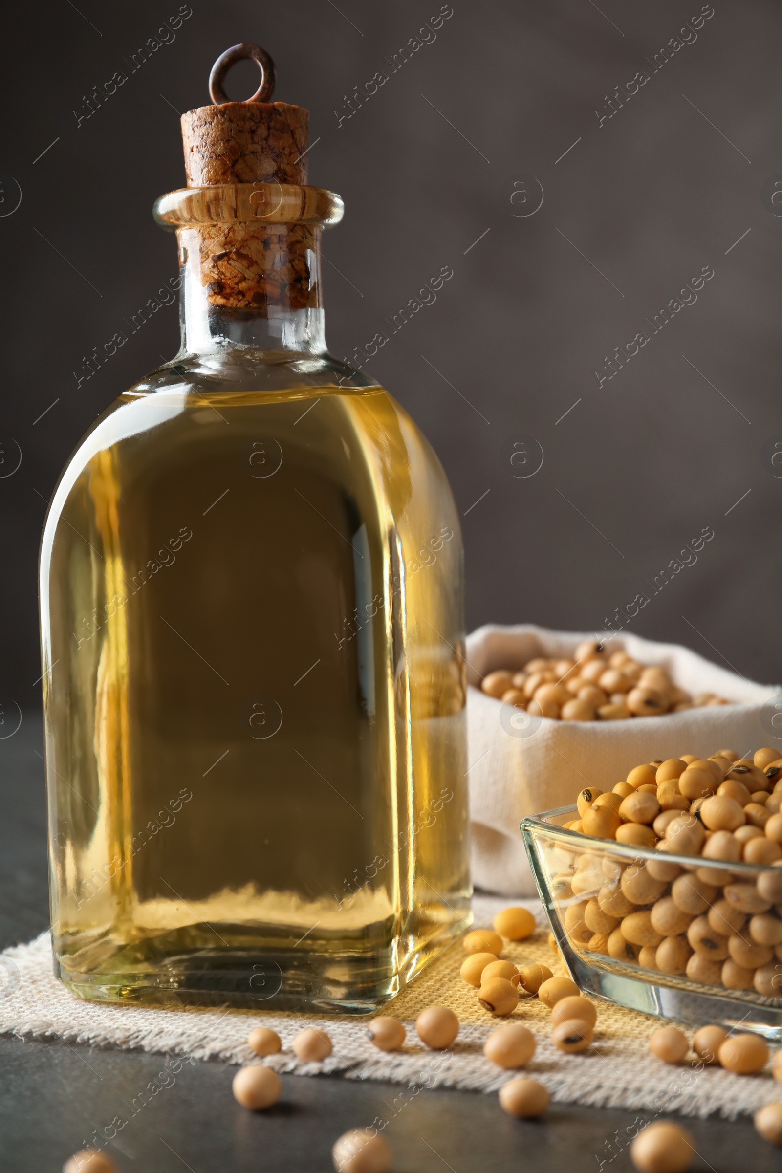 Photo of Composition with soybean oil on grey table