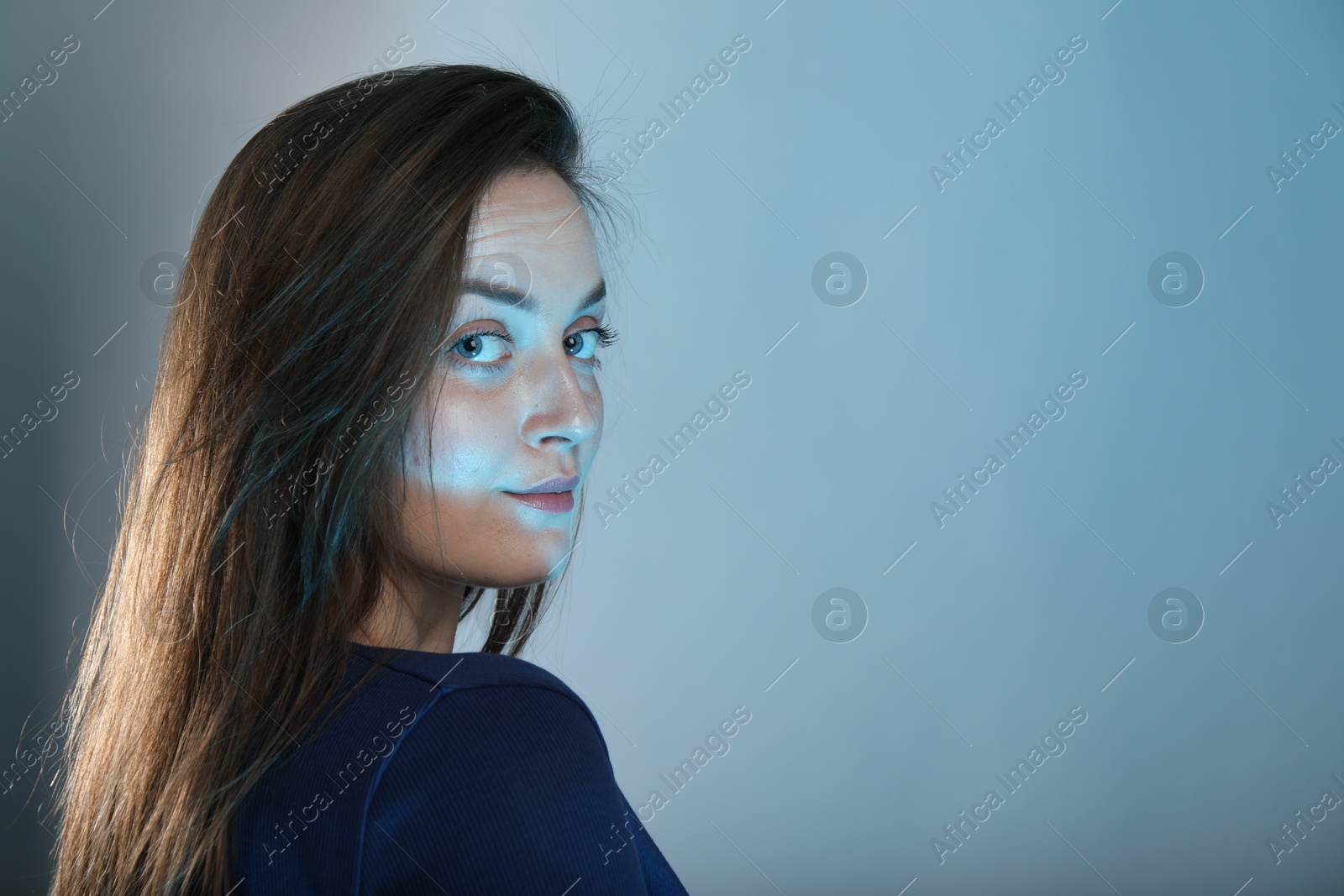 Photo of Portrait of beautiful woman on color background, space for text