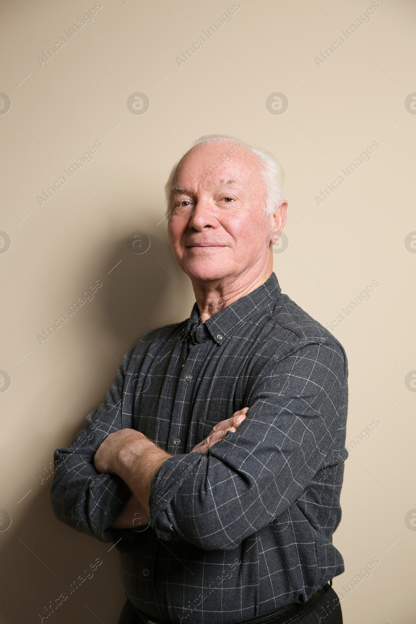 Photo of Portrait of elderly man on color background