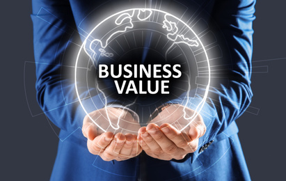 Image of Business value concept. Man demonstrating digital world globe