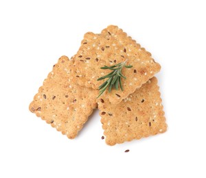 Photo of Stack of cereal crackers with flax, sesame seeds and rosemary isolated on white, above view