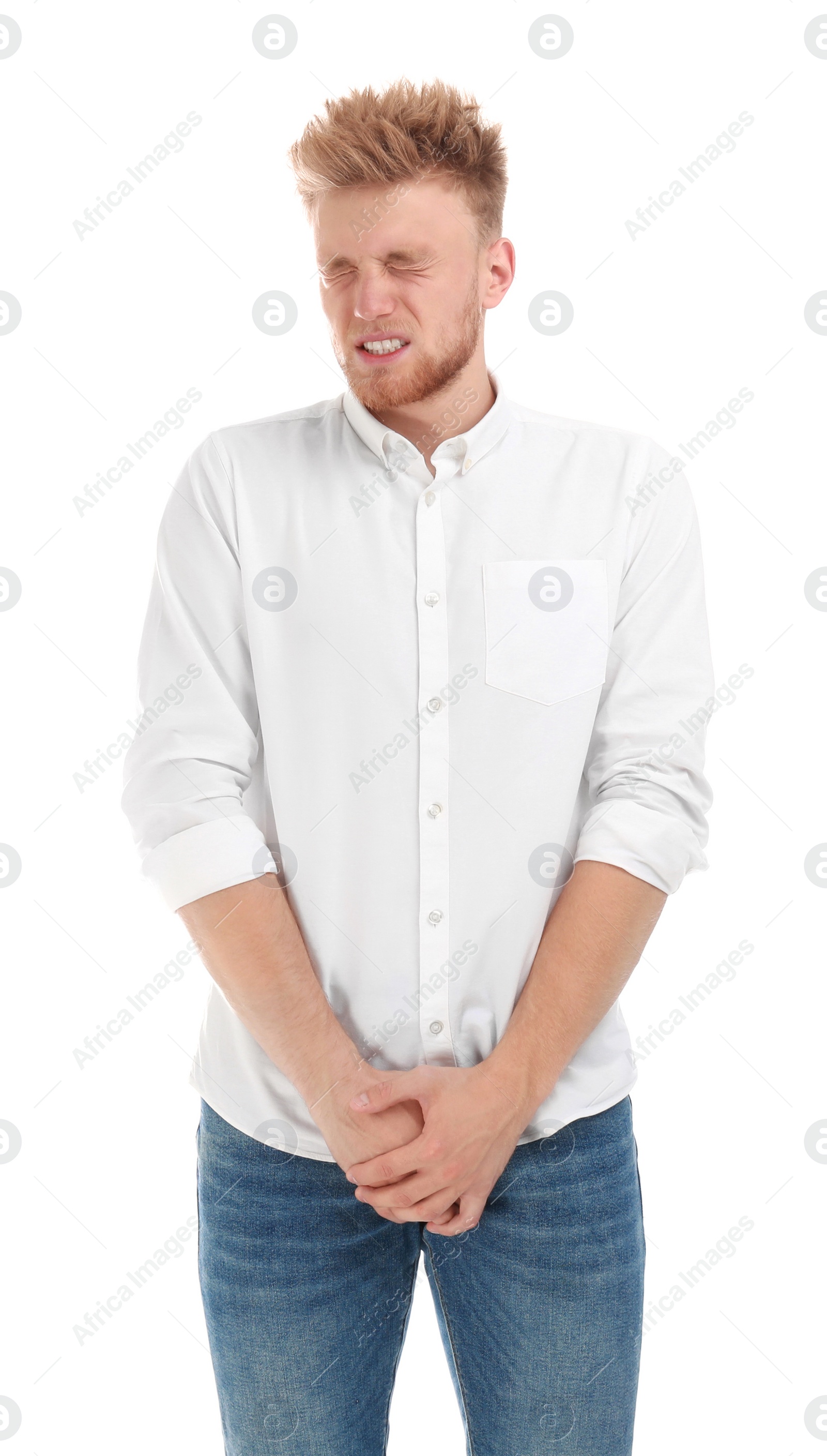 Photo of Young man suffering from pain on white background. Urology problems